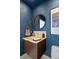 Chic powder room with dark blue walls and floating vanity at 175 1St S St # 3402, St Petersburg, FL 33701