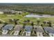 Aerial view showcasing a community near a golf course and lake at 2438 Sifield Greens Way # 44, Sun City Center, FL 33573