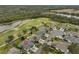 Aerial view of a house in a golf course community near a lake at 2438 Sifield Greens Way # 44, Sun City Center, FL 33573