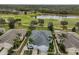 Aerial view of a house and neighborhood with golf course and pond at 2438 Sifield Greens Way # 44, Sun City Center, FL 33573