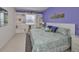 Spacious bedroom with large bed, built-in shelves, and light purple walls at 2438 Sifield Greens Way # 44, Sun City Center, FL 33573