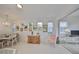 Bright dining room, chandelier, hardwood floors, view to backyard at 2438 Sifield Greens Way # 44, Sun City Center, FL 33573