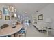 Bright dining room with chandelier and view into living room at 2438 Sifield Greens Way # 44, Sun City Center, FL 33573