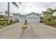 Two-car garage, light-blue exterior, landscaping at 2438 Sifield Greens Way # 44, Sun City Center, FL 33573