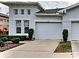 Light-blue exterior, two-car garage, front yard at 2438 Sifield Greens Way # 44, Sun City Center, FL 33573