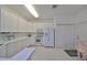 Bright eat-in kitchen with white cabinets and modern appliances at 2438 Sifield Greens Way # 44, Sun City Center, FL 33573