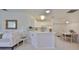 Open kitchen, white cabinets, breakfast bar, dining area at 2438 Sifield Greens Way # 44, Sun City Center, FL 33573