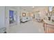 Open living room with white sofa and view of bedroom and kitchen at 2438 Sifield Greens Way # 44, Sun City Center, FL 33573