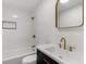 Modern bathroom with white tile and gold fixtures at 25888 Whipperwill St, Brooksville, FL 34601