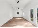 Bright bedroom with hardwood floors and access to a patio at 25888 Whipperwill St, Brooksville, FL 34601