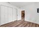 Bedroom with hardwood floors and views of the backyard at 25888 Whipperwill St, Brooksville, FL 34601