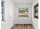 Bright entryway with wood-look flooring and sunlit windows at 25888 Whipperwill St, Brooksville, FL 34601