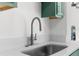 Modern kitchen sink and faucet with white countertops at 25888 Whipperwill St, Brooksville, FL 34601