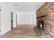 Spacious living area with brick fireplace and hardwood floors at 25888 Whipperwill St, Brooksville, FL 34601