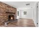 Living room with brick fireplace and new flooring at 25888 Whipperwill St, Brooksville, FL 34601