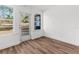 Sunroom with hardwood floors, white walls and access to backyard at 25888 Whipperwill St, Brooksville, FL 34601