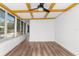 Sunroom features hardwood floors, white walls, and bright windows at 25888 Whipperwill St, Brooksville, FL 34601