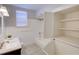 Bathroom with a tub, built-in shelving, and linen closet at 2701 W Cordelia St, Tampa, FL 33607