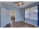 Light and airy bedroom featuring wood floors and a view of the living room at 2701 W Cordelia St, Tampa, FL 33607