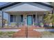 Charming house exterior with a welcoming front porch and landscaped yard at 2701 W Cordelia St, Tampa, FL 33607