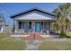 Quaint house with a teal front door and brick steps at 2701 W Cordelia St, Tampa, FL 33607