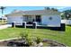 White house with a two-car garage and landscaped lawn at 289 Monte Cristo Blvd, St Petersburg, FL 33715