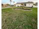 Well-maintained lawn with a kidney-shaped garden bed in front of the house at 289 Monte Cristo Blvd, St Petersburg, FL 33715