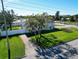 White house with a gray roof, palm trees, and a green lawn at 289 Monte Cristo Blvd, St Petersburg, FL 33715