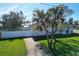 White house with a driveway, green lawn, and white fence at 289 Monte Cristo Blvd, St Petersburg, FL 33715