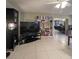 Living room with large TV, bookcase, and view into dining area at 289 Monte Cristo Blvd, St Petersburg, FL 33715
