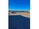 Empty parking lot with a view of the water and some cars at 289 Monte Cristo Blvd, St Petersburg, FL 33715