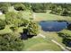 Golf course with pond and walking path from above at 3340 Mcmath Dr, Palm Harbor, FL 34684