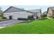 White brick home with gray accents, two-car garage, and lush lawn at 3340 Mcmath Dr, Palm Harbor, FL 34684