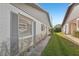 Side view of the house showcasing gray shutters and landscaping at 3340 Mcmath Dr, Palm Harbor, FL 34684