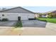 Two-car garage with white doors and brick exterior at 3340 Mcmath Dr, Palm Harbor, FL 34684