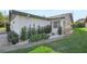 White house exterior with grey roof and landscaping at 3340 Mcmath Dr, Palm Harbor, FL 34684