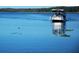 Tranquil lake view with a small boat at 3340 Mcmath Dr, Palm Harbor, FL 34684