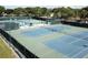 Community tennis courts with seating and shade at 3340 Mcmath Dr, Palm Harbor, FL 34684