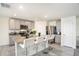 Modern kitchen with granite island, stainless steel appliances, and gray cabinets at 38311 Sonnet Landing Ave, Zephyrhills, FL 33540