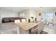 Open floor plan with kitchen island, stainless steel appliances, and spacious living room at 38311 Sonnet Landing Ave, Zephyrhills, FL 33540