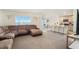 Spacious living room with a large sectional sofa and view of the kitchen at 38311 Sonnet Landing Ave, Zephyrhills, FL 33540