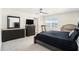 Main bedroom with a king-size bed, dresser, and a TV at 38311 Sonnet Landing Ave, Zephyrhills, FL 33540
