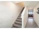 Modern staircase with grey carpet leading to the second floor at 38311 Sonnet Landing Ave, Zephyrhills, FL 33540