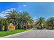 Gated community entrance with lush landscaping and signage at 4098 Las Palmas Way, Sarasota, FL 34238