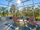 Covered patio with seating area overlooking lush landscaping at 4098 Las Palmas Way, Sarasota, FL 34238