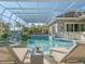Inviting pool and spa with covered patio, lush landscaping, and comfortable lounge chairs at 4098 Las Palmas Way, Sarasota, FL 34238