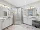 Elegant bathroom with double sinks, a large shower, and modern fixtures at 4719 Avila Lakes Dr, Wimauma, FL 33598