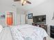 Bright bedroom featuring a large TV and ensuite bathroom at 4719 Avila Lakes Dr, Wimauma, FL 33598