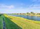 Peaceful backyard oasis with serene canal views and lush grass at 4719 Avila Lakes Dr, Wimauma, FL 33598