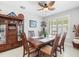 Spacious dining room with wood table and chairs, and built-in hutch at 4719 Avila Lakes Dr, Wimauma, FL 33598
